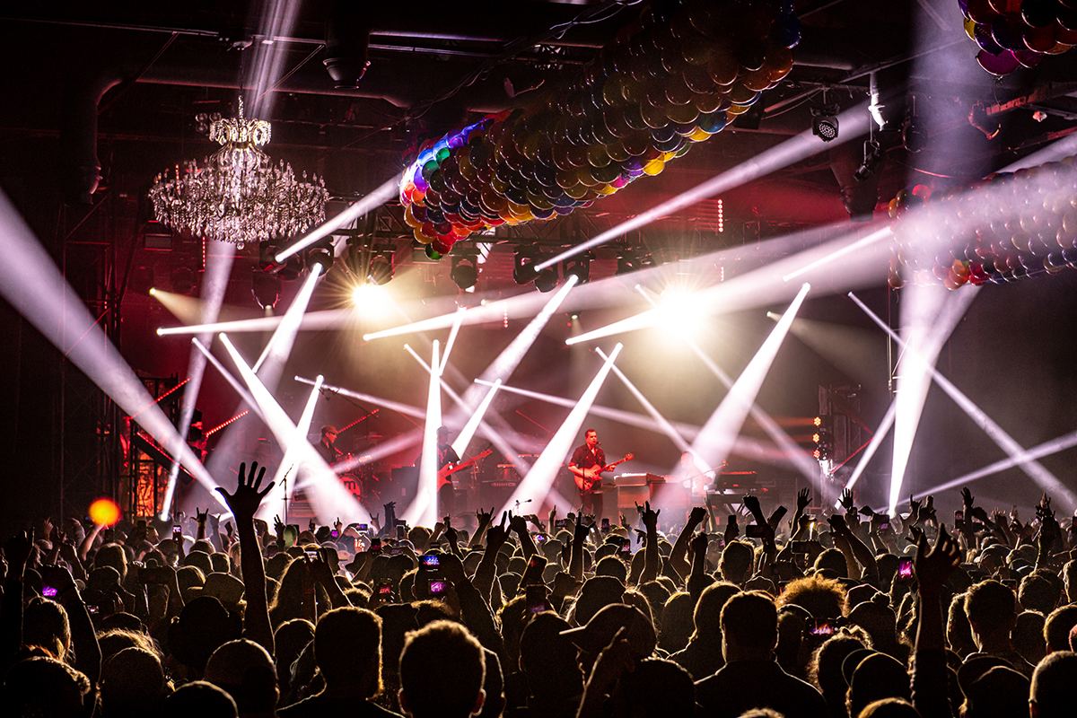 Arena filled with bright stage lights before a show