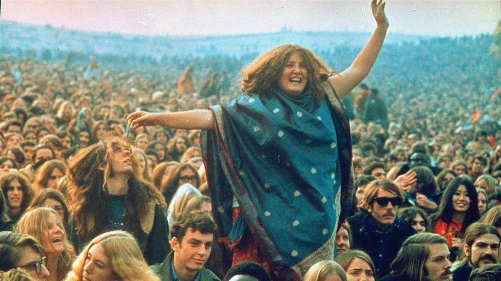 Joyful festival crowd enjoying live music, illustrating Spotify Free vs Premium