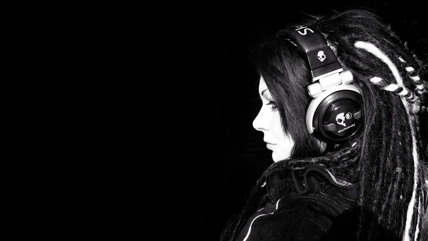Listener wearing headphones in a dark room